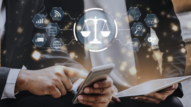 253352705_l Two professionals engage with a smartphone and tablet, surrounded by digital icons representing law, technology, and communication.